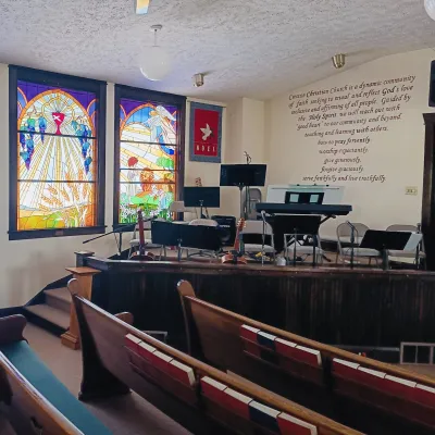 Sanctuary with pews and stained glass windows
