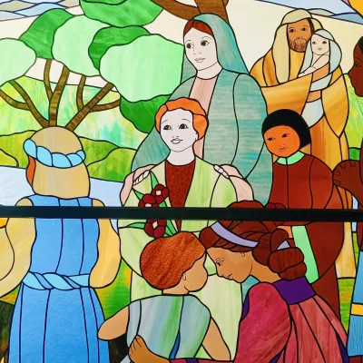 Stained glass depicting community of people
