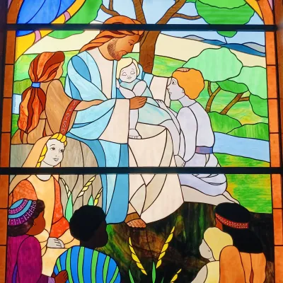 Stained glass depicting Jesus with children